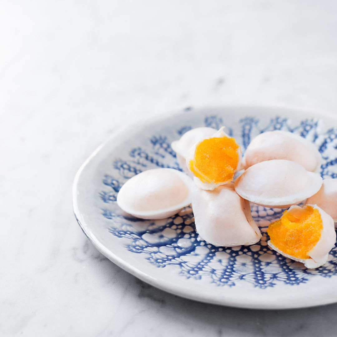 Traditional Portuguese soft-egg confectionery on a blue-and-white patterned plate
